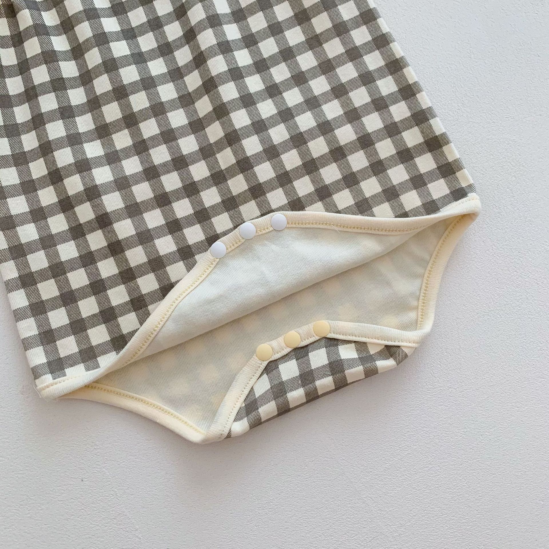 チェック柄キャミソールロンパースの股下スナップ部分
