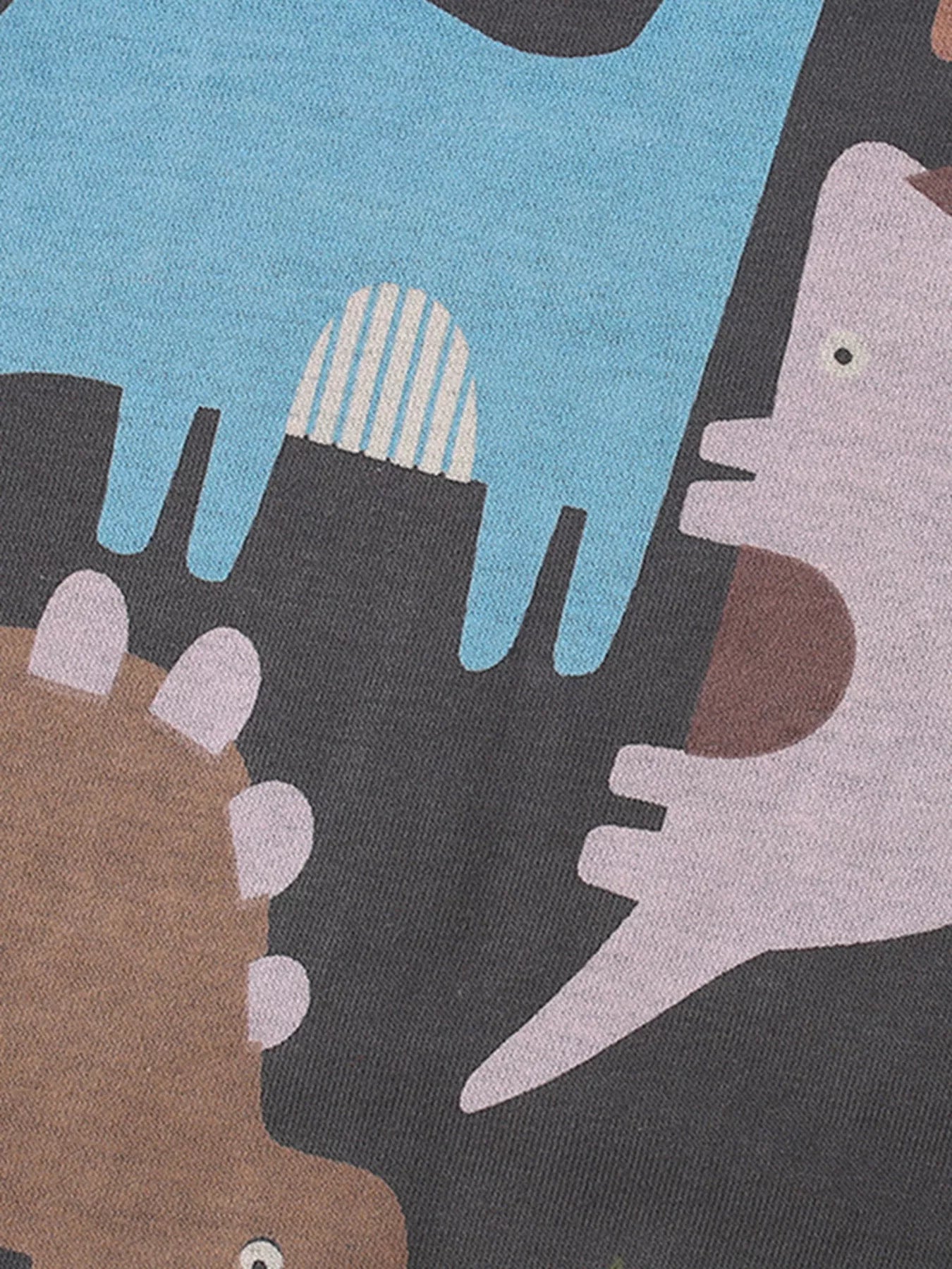 恐竜シルエット柄が大きくプリントされたキッズスウェット生地のクローズアップ
