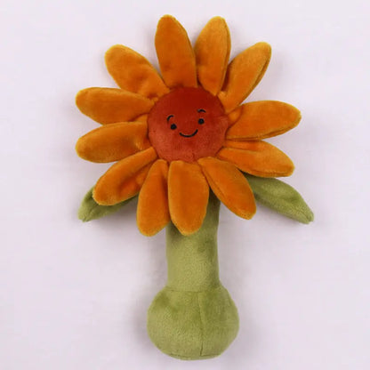 オレンジの花びらが放射状に広がるひまわりモチーフBIBIぬいぐるみラトルの正面写真  
