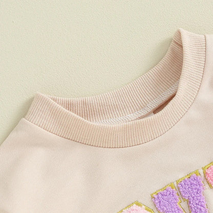 クルーネックの襟元ディテールが分かるアプリコット長袖ロンパース
