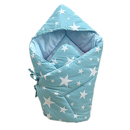 ブルーの王冠柄ベビーおくるみに赤ちゃんがくるまれている写真（ベビーおくるみ ブルー 王冠柄 純綿）
