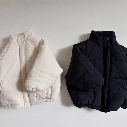 ハンガーにかけられた無地デザインの子供用秋冬アウター
