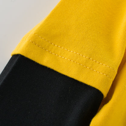 ゴールデンイエローの身頃とブラック袖の切り替え縫い目ディテール
