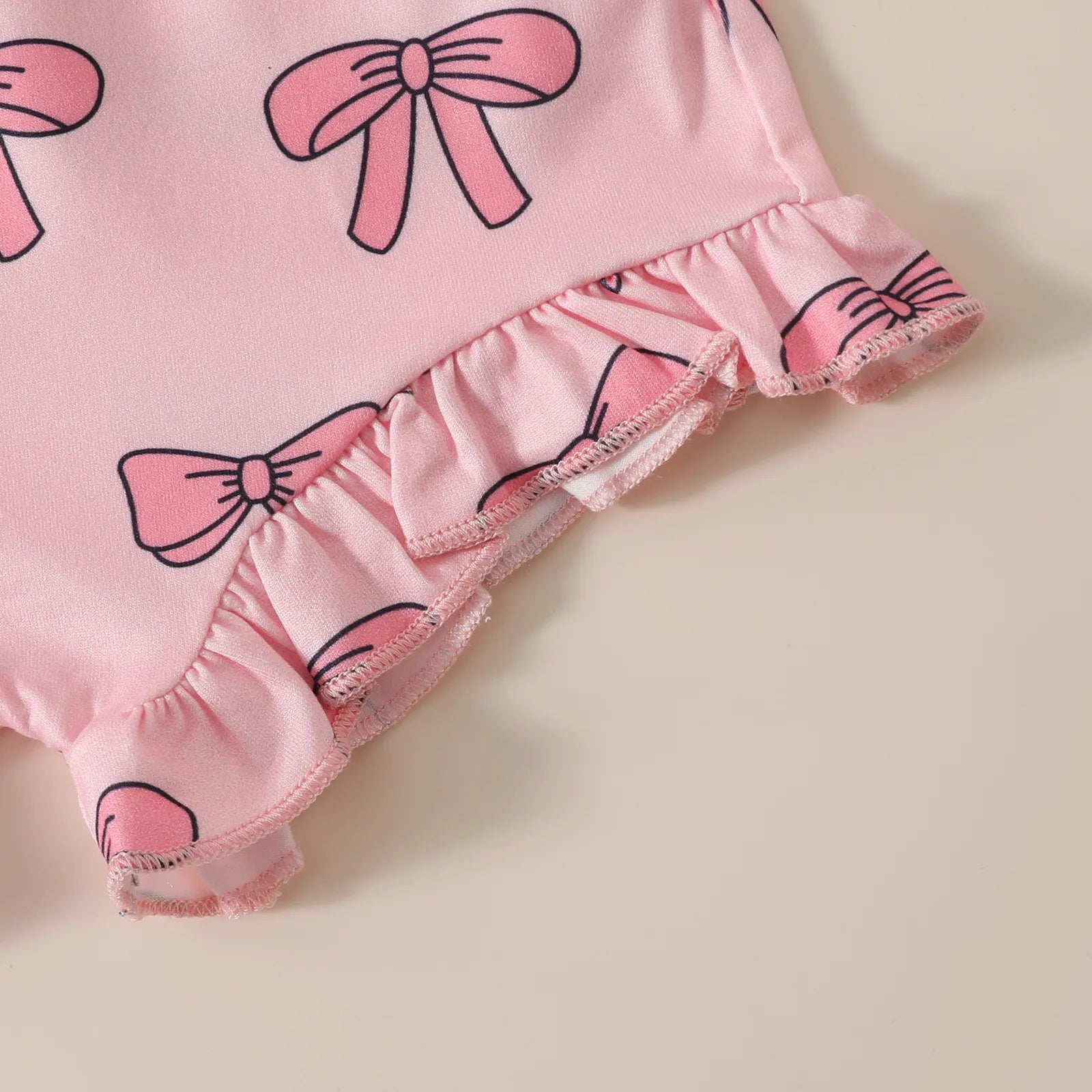 ショートパンツの裾フリルとリボン柄プリントのディテール
