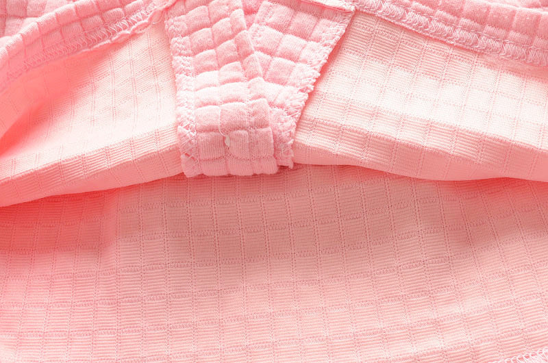 フラワーデザイン付き長袖トップスの正面写真
