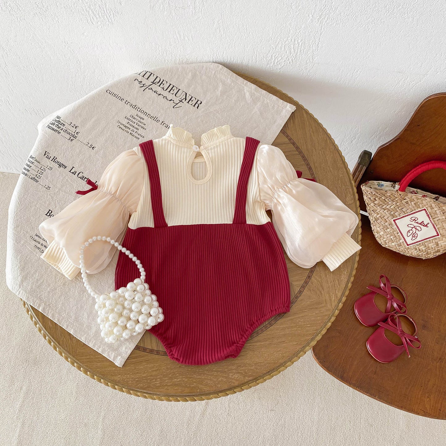 上品アプリコットで特別感をまとう 女の子ベビーロンパース リボンデザイン 長袖 コットン クラスA 66~90cm