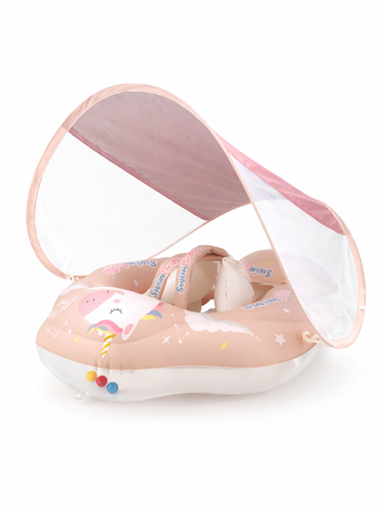 ピンクベージュのユニコーン柄ベビー用スイムフロート（座席・固定ベルト付き）と半透明のサンシェード付きキャノピーを、白背景で撮影した商品画像。
