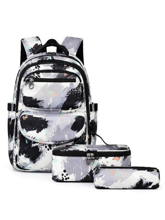 黒・白・グレーのスプラッターペイント柄の3点セット（バックパック、ランチバッグ、ペンケース）が、白背景で並んだ商品写真。