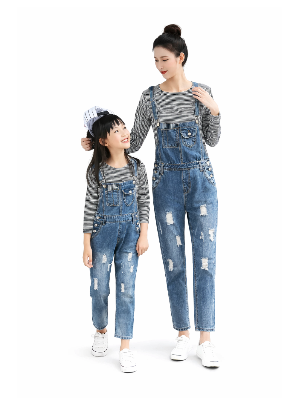 白背景のスタジオで、親子のモデルが同じデニムのダメージサロペットとグレー×白のボーダートップスを着用して立っている。子どもはキャップを被り、正面から全身が見える。
