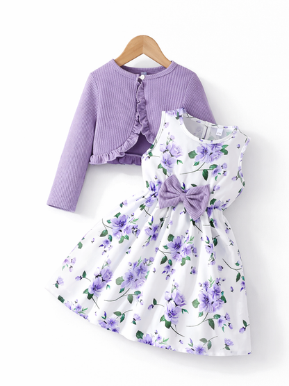 白地に紫の花柄が映える女の子用ワンピースと、ラベンダー色のリブカーディガンの2点セット。ウエストに大きなリボン付きのノースリーブワンピースと、フリル縁の長袖ボレロ風カーディガン。
