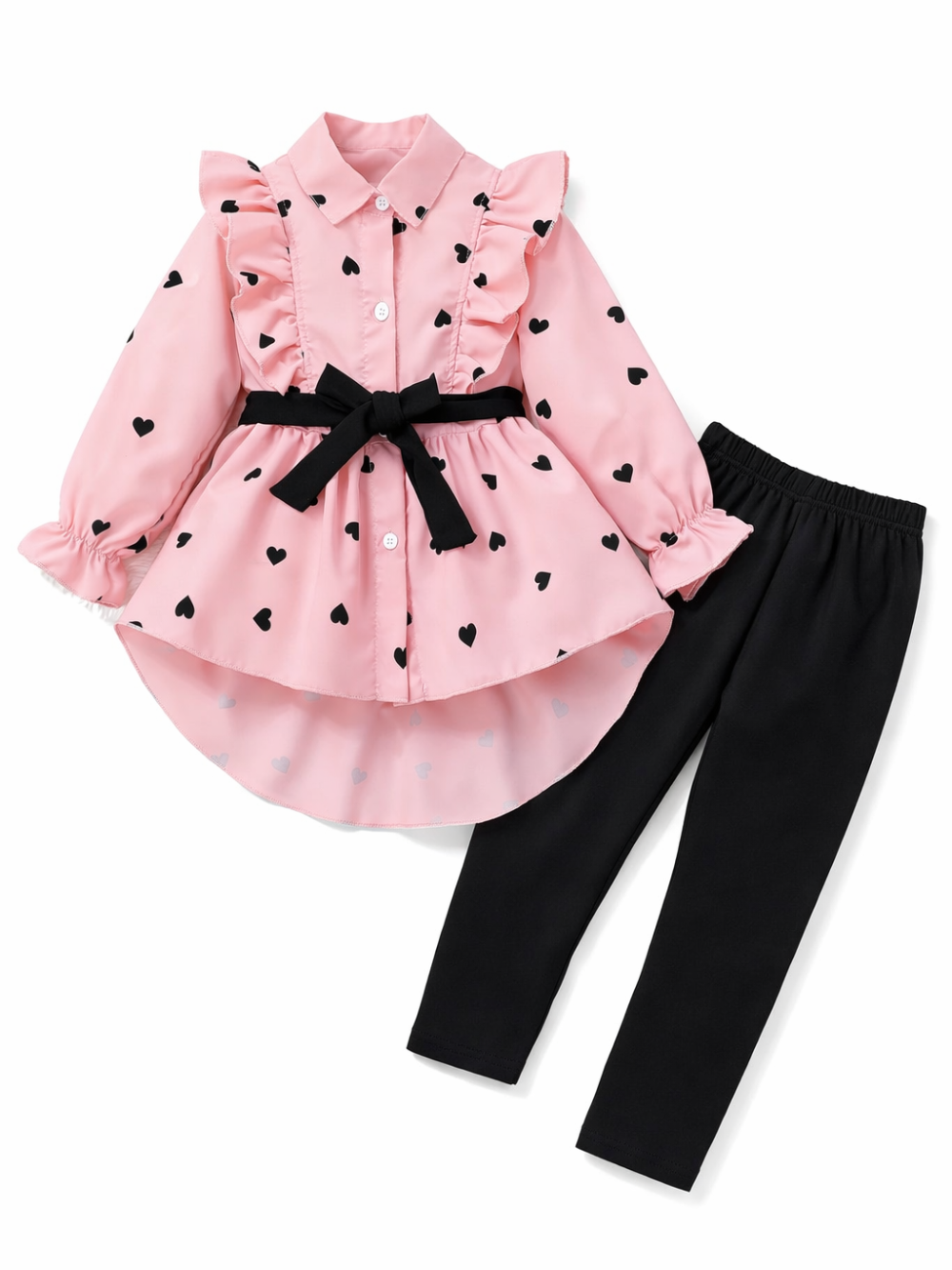 白背景にフラットレイで配置された、黒ハート柄のピンク長袖フリルチュニック（黒リボンベルト付き）と、黒レギンスのキッズ2点セット。
