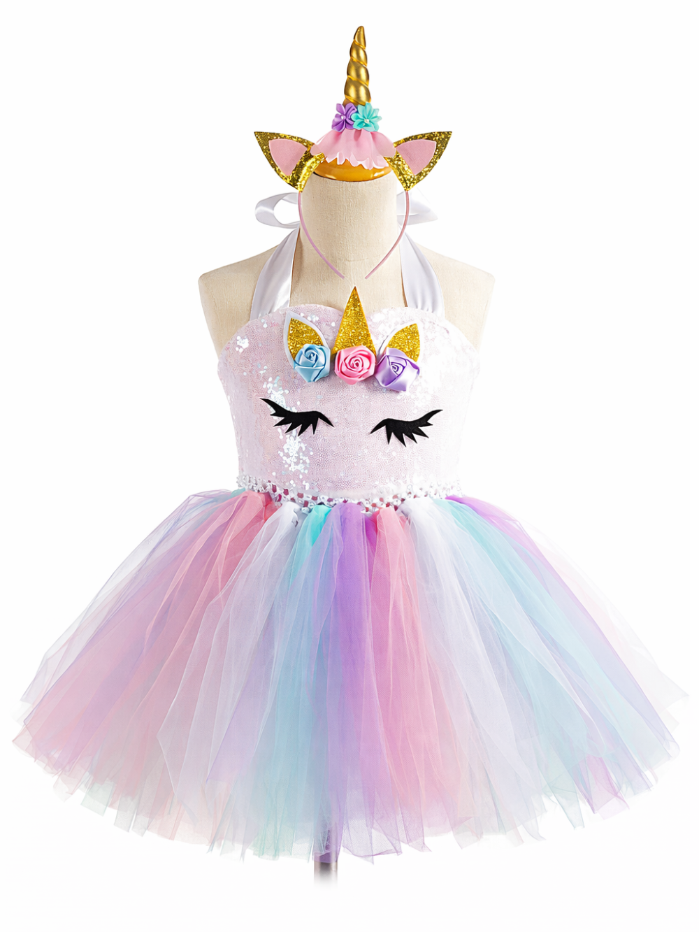 ユニコーンモチーフの子ども用チュチュドレス（スパンコールの白いホルターネックトップ、パステルカラーのチュールスカート）をマネキンに着せ、ユニコーン角付きカチューシャと一緒に白背景で撮影した商品画像。
