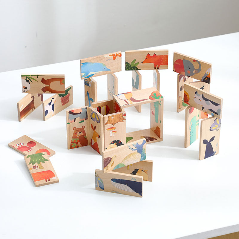 動物柄の木製ドミノピースを立てて並べた様子。白いテーブル上に迷路のような形に組まれている。