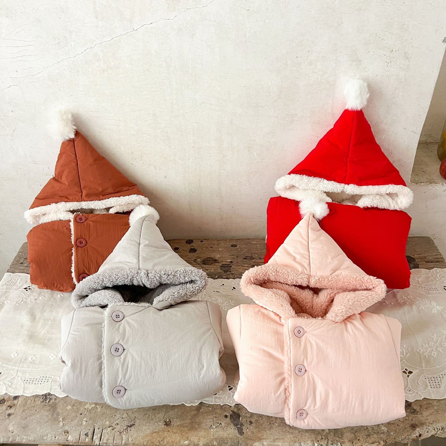 コートの内側ボア裏地と縫製が見えるように前を開けたベビーコート
