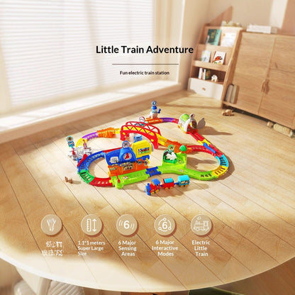 室内の床にカラフルなレールを広げ、駅や橋を組み合わせた電動トレインセットの全体イメージ
