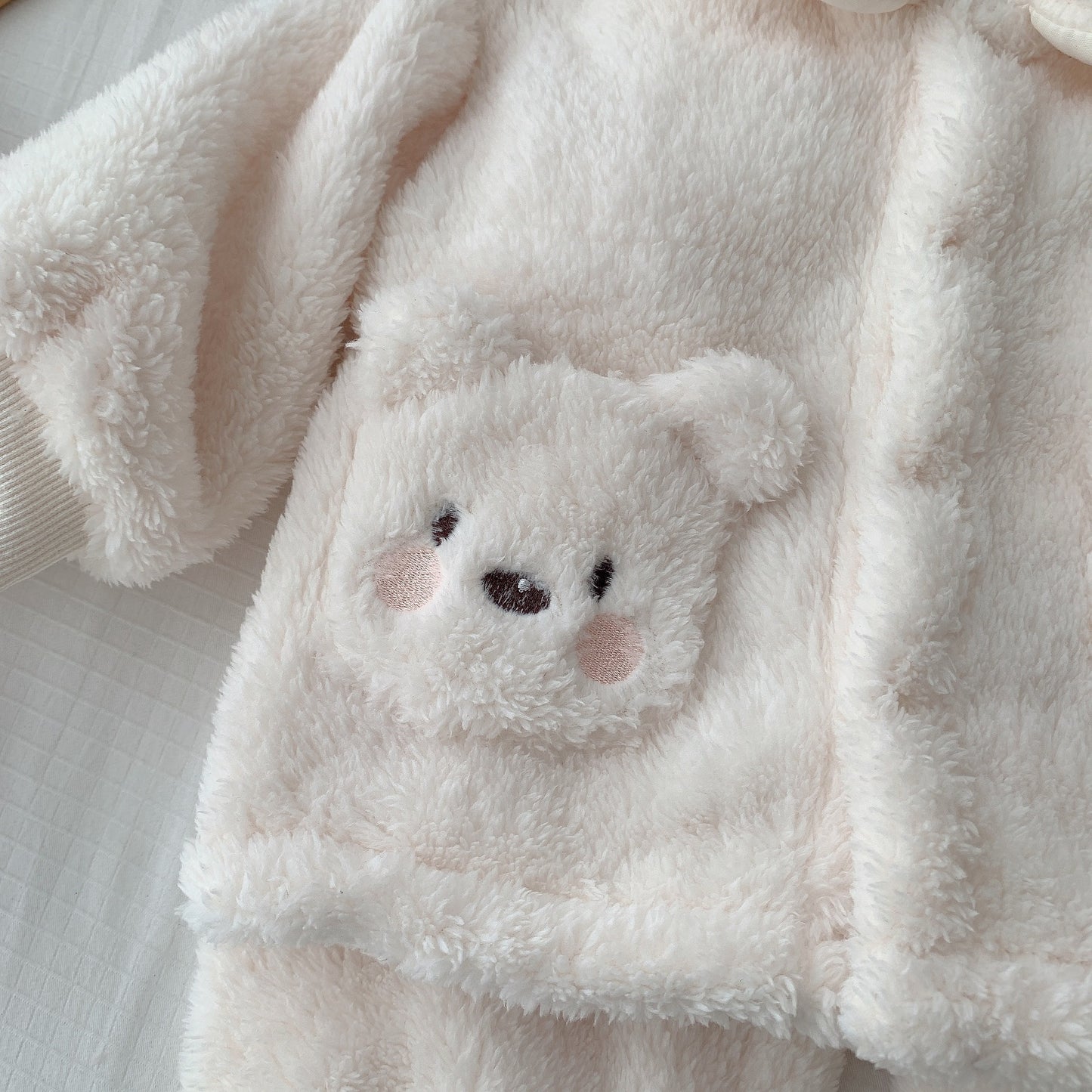 前面ポケットにくまフェイス刺繍が入ったホワイトボアジャケットのディテールアップ
