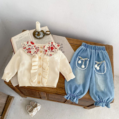 アプリコットホワイトの柔らかい色味のベビーカーディガン
