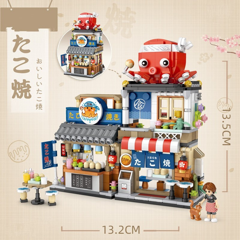 たこ焼き屋台をテーマにしたミニブロックセット。巨大な赤いタコの看板、青い木造2階建ての店舗、赤白ストライプの屋根、のれん、カウンターに並ぶ具材や鉄板、注文窓口、屋台ライト、看板パネル、調理器具、小物フード、女性フィギュアと犬フィギュア付き。細部まで再現された日本風屋台デザインで、集中力・創造力・空間認識力を育てる知育ビルディングトイ。サイズ13.2×13.5cm。
