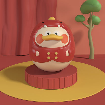 レッドダイナソーデザインのタンブラーラトルが前後に揺れて音を鳴らしているイメージの商品写真
